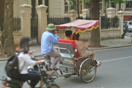 Bike tuk-tuk in Vietnam.  Multi-tasking on the phone naturally.